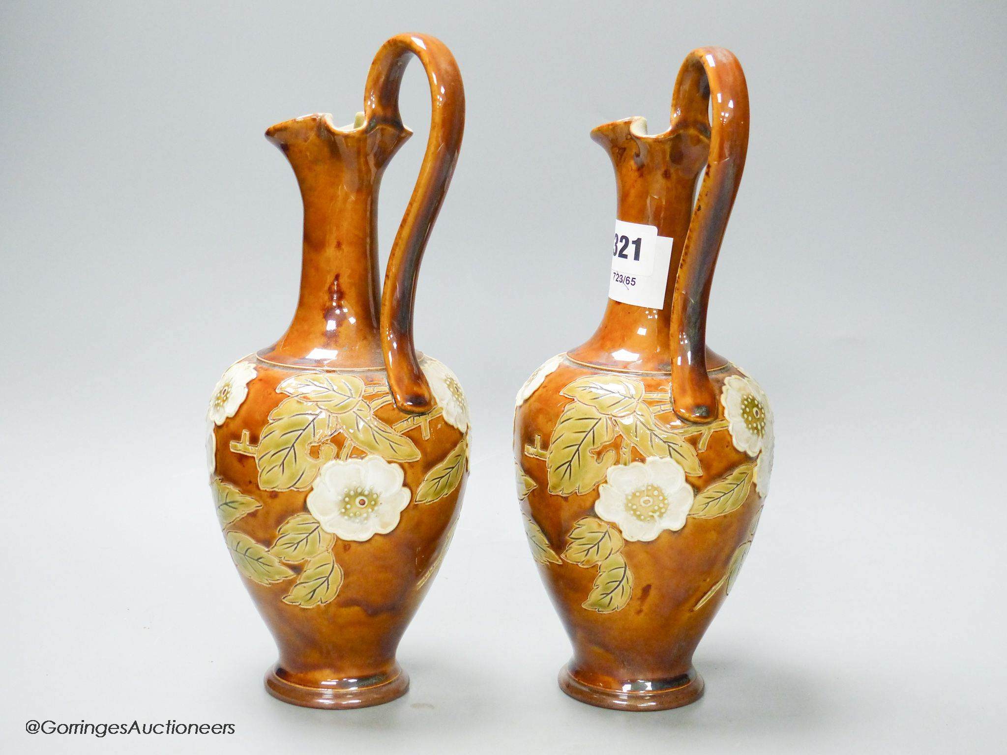 A pair of Royal Doulton stoneware ewers, height 30cm